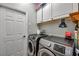 Functional laundry room with front-load washer and dryer and storage cabinets above at 9309 Edistro Pl, New Port Richey, FL 34654