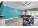 Bright living room with sectional sofa and access to the outdoor patio at 9309 Edistro Pl, New Port Richey, FL 34654