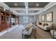 Comfortable lounge area with stylish seating, a large TV, and elegant decor at 9309 Edistro Pl, New Port Richey, FL 34654