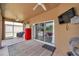 Covered patio featuring a red refrigerator, mounted TV, and access to indoor and outdoor spaces at 9309 Edistro Pl, New Port Richey, FL 34654