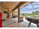 Spacious screened-in patio with outdoor seating area, grill, and view of the water at 9309 Edistro Pl, New Port Richey, FL 34654