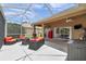 Screened in patio area with outdoor seating, grill and scenic views of the pond at 9309 Edistro Pl, New Port Richey, FL 34654