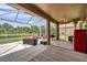 Large screened lanai with patio seating, BBQ, and a clear view of the pond at 9309 Edistro Pl, New Port Richey, FL 34654