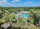 Aerial view of community pool and clubhouse offering a perfect blend of relaxation and recreation at 9309 Edistro Pl, New Port Richey, FL 34654