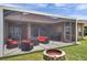 Relax on the screened patio, complete with ceiling fans, outdoor furniture, and a cozy fire pit for evening gatherings at 9309 Edistro Pl, New Port Richey, FL 34654