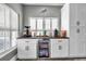 Wet bar area with beverage cooler and cabinetry at 9309 Edistro Pl, New Port Richey, FL 34654