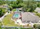 An aerial view showcases the backyard, pool, landscaping and spacious layout of the property at 9431 Spring Hill Dr, Spring Hill, FL 34608