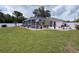 View of landscaped yard with screened pool, patio, and white privacy fence at 9431 Spring Hill Dr, Spring Hill, FL 34608