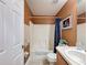 Functional bathroom featuring a shower, toilet, sink, and storage space, ideal for everyday use at 9431 Spring Hill Dr, Spring Hill, FL 34608