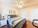 Bright bedroom with hardwood floors, ceiling fan, and a spacious closet for ample storage at 9431 Spring Hill Dr, Spring Hill, FL 34608