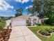 Charming single-story home featuring a well-manicured lawn and a two-car garage at 9431 Spring Hill Dr, Spring Hill, FL 34608