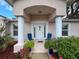 Inviting front porch with decorative plants and comfortable seating at 9431 Spring Hill Dr, Spring Hill, FL 34608