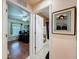 Hallway view between an office with hardwood floors and a bathroom with a white door at 9431 Spring Hill Dr, Spring Hill, FL 34608