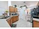Kitchen with stainless steel appliances, wood cabinets, tile floors and view to the dining room at 9431 Spring Hill Dr, Spring Hill, FL 34608