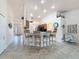 Living room with breakfast bar, vaulted ceilings, tile floors, and view of front entryway at 9431 Spring Hill Dr, Spring Hill, FL 34608