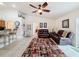 Living room with vaulted ceilings, ceiling fan, tile floors, access to other rooms and breakfast bar at 9431 Spring Hill Dr, Spring Hill, FL 34608