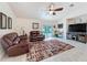 Open living room with tile flooring, ceiling fan, stylish furnishings, and sliding glass doors to the pool area at 9431 Spring Hill Dr, Spring Hill, FL 34608