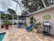 Relaxing screened-in patio featuring lounge chairs, creating a comfortable outdoor living space at 9431 Spring Hill Dr, Spring Hill, FL 34608