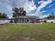 A screened-in pool area offers privacy and relaxation with ample space and a well-maintained lawn at 9431 Spring Hill Dr, Spring Hill, FL 34608