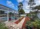 The backyard features a beautifully landscaped pool area with a garden at 9431 Spring Hill Dr, Spring Hill, FL 34608