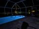 Screened pool features lighting, privacy and easy access to patio at 9431 Spring Hill Dr, Spring Hill, FL 34608