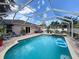 Stunning screened-in pool and spa area, creating an ideal outdoor oasis for relaxation and enjoyment at 9431 Spring Hill Dr, Spring Hill, FL 34608