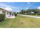 This property features a spacious backyard with lush green grass and an enclosed patio at 9433 Stonewall Ln, New Port Richey, FL 34655