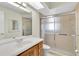 Bathroom featuring a light wood vanity and a glass-enclosed shower at 9433 Stonewall Ln, New Port Richey, FL 34655