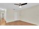 Spacious bedroom features wood floors, a ceiling fan and access to the hallway at 9433 Stonewall Ln, New Port Richey, FL 34655