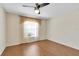 Cozy bedroom with laminate floors and a large window at 9433 Stonewall Ln, New Port Richey, FL 34655