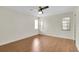Light-filled bedroom with wood floors, ceiling fan, and ample natural light at 9433 Stonewall Ln, New Port Richey, FL 34655