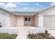 Welcoming entryway with a covered porch and charming brick accents at 9433 Stonewall Ln, New Port Richey, FL 34655