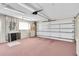 Clean and spacious two-car garage with ample storage space and a window at 9433 Stonewall Ln, New Port Richey, FL 34655