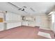 View of garage featuring a utility sink, laundry, shelving, and storage cabinets at 9433 Stonewall Ln, New Port Richey, FL 34655