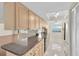 Bright kitchen with light wood cabinets, granite counters, and stainless steel appliances at 9433 Stonewall Ln, New Port Richey, FL 34655