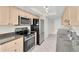 Well-equipped kitchen boasting granite counters, stainless steel appliances, and tiled flooring at 9433 Stonewall Ln, New Port Richey, FL 34655