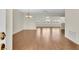 Spacious open-concept living room showcasing beautiful hardwood floors and a view into other rooms at 9433 Stonewall Ln, New Port Richey, FL 34655