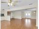 Spacious living room with wood floors and entry to kitchen and front door at 9433 Stonewall Ln, New Port Richey, FL 34655