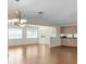 Bright living room with wood flooring, large windows and an elegant chandelier at 9433 Stonewall Ln, New Port Richey, FL 34655