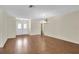 Open living room with wood floors, neutral walls, and bright front door at 9433 Stonewall Ln, New Port Richey, FL 34655
