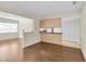 Spacious open-concept room with hardwood floors and a partial wall overlooking other areas of the home at 9433 Stonewall Ln, New Port Richey, FL 34655
