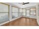 Sunroom featuring multiple windows, blinds, and a ceiling fan at 9433 Stonewall Ln, New Port Richey, FL 34655