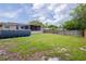 Large backyard featuring an above ground pool, screened patio, and fenced perimeter at 9635 Century Dr, Spring Hill, FL 34608