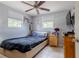 Bedroom with a wood frame bed, two windows for natural light, and neutral paint at 9635 Century Dr, Spring Hill, FL 34608
