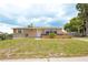Well-maintained single-story home with a neat front lawn and an inviting entrance at 9635 Century Dr, Spring Hill, FL 34608
