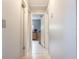 Hallway features tile flooring, neutral paint, and doors to bedrooms and closets at 9635 Century Dr, Spring Hill, FL 34608