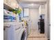Bright laundry room with washer, dryer, storage shelves, and natural light at 9635 Century Dr, Spring Hill, FL 34608