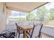Screened porch with table and chairs at 9635 Century Dr, Spring Hill, FL 34608