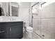 Bathroom featuring a glass-enclosed shower, a modern vanity with a quartz countertop, and a sleek silver-framed mirror at 9704 Milano Dr, Trinity, FL 34655