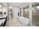 Serene bathroom with soaking tub, glass shower, and neutral tones at 9704 Milano Dr, Trinity, FL 34655